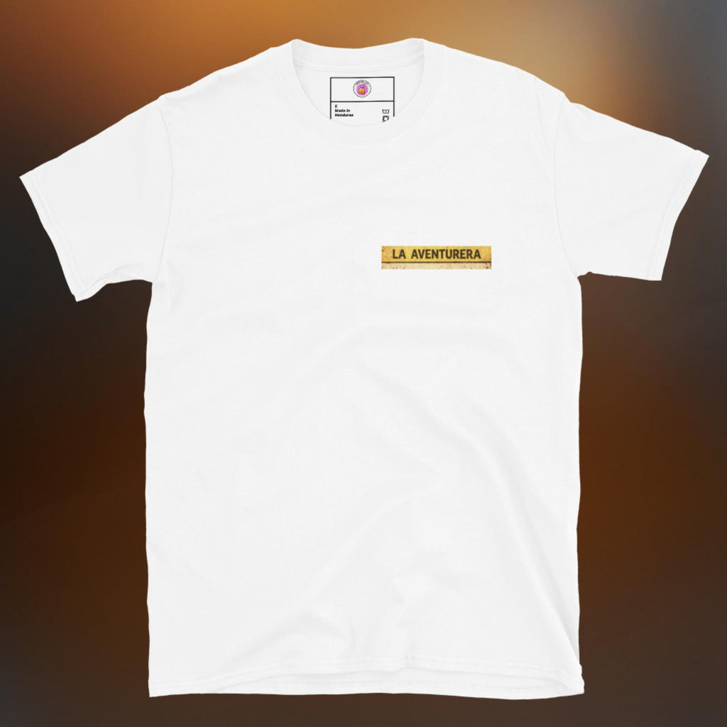Latino apparel graphic tee featuring a vintage Mexican Loteria card design labeled "LA AVENTURERA" with a cyclist riding a bike, perfect for summer streetwear and cycling enthusiasts.