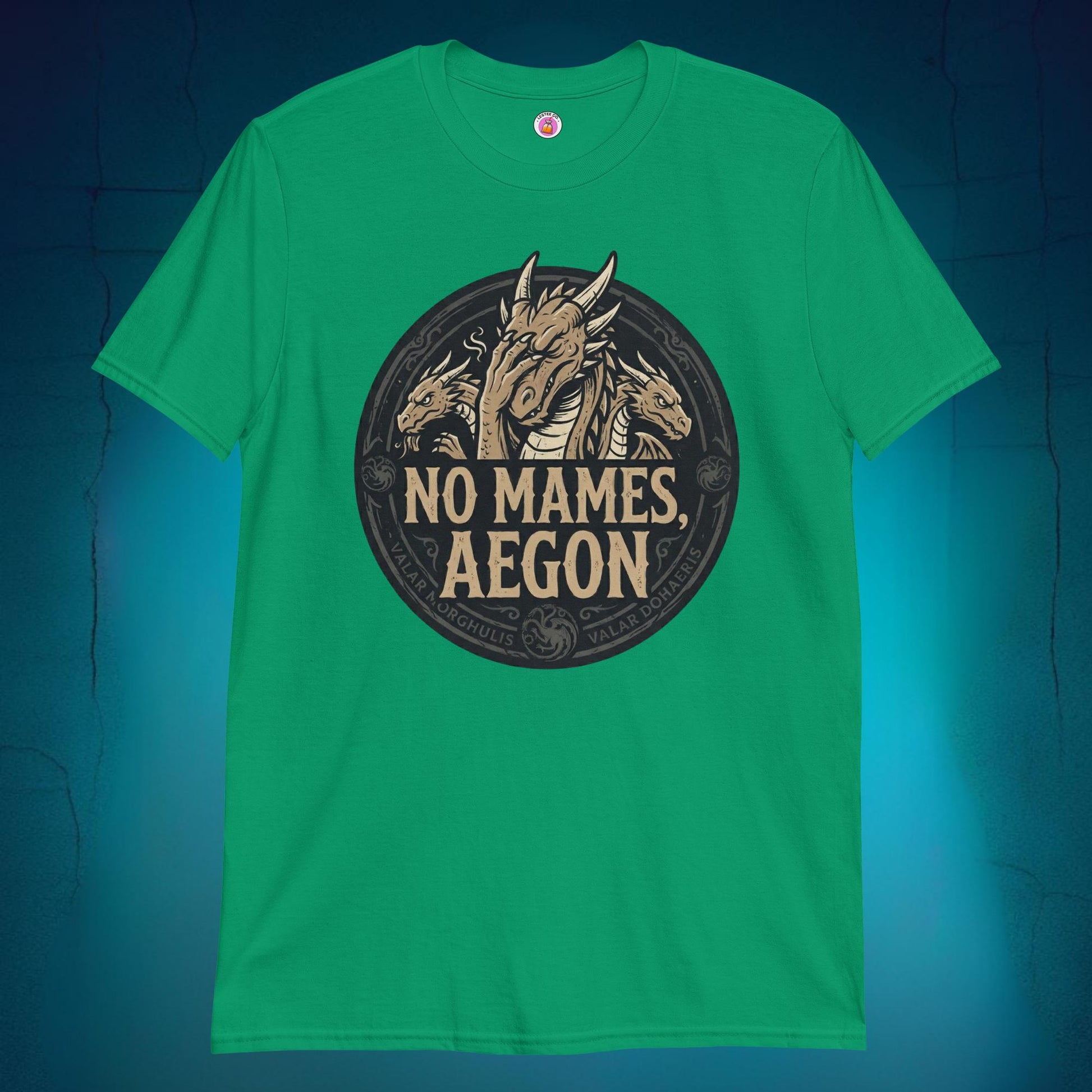 A close-up mockup of a unisex t-shirt featuring a graphic design of a dragon with a disappointed facial expression and the funny Spanish phrase text "no mames Aegon" written underneath.