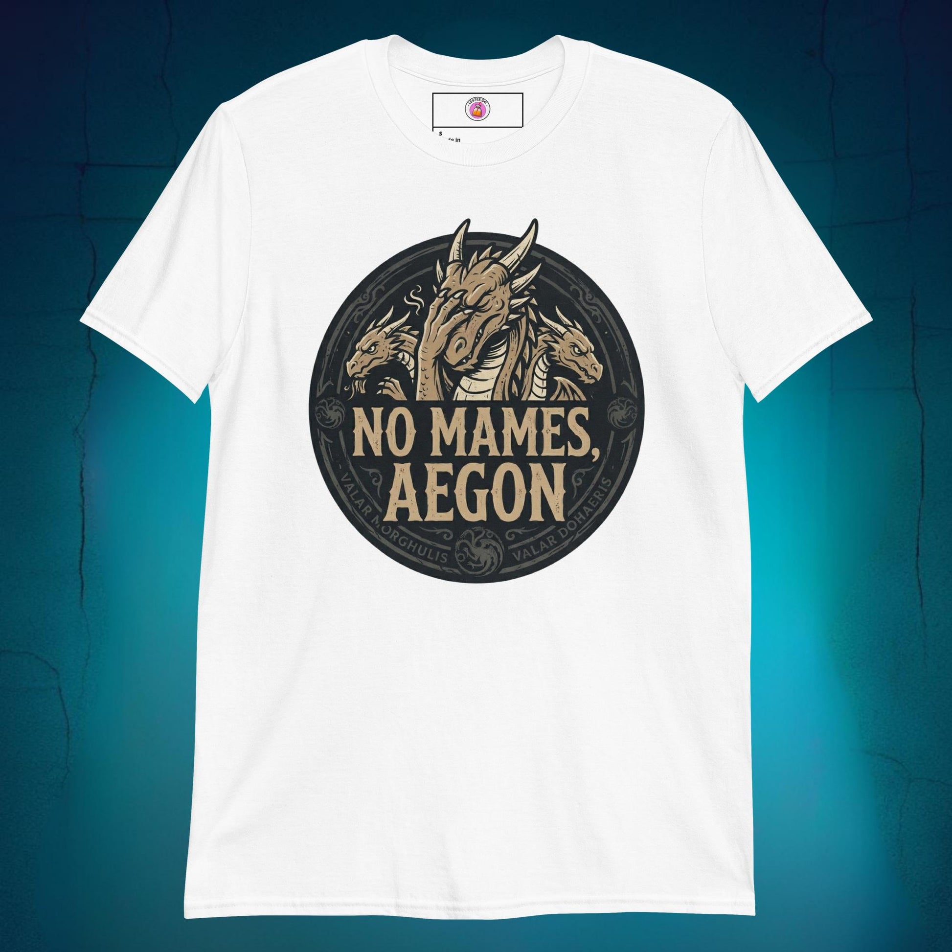 A close-up mockup of a unisex t-shirt featuring a graphic design of a dragon with a disappointed facial expression and the funny Spanish phrase text "no mames Aegon" written underneath.